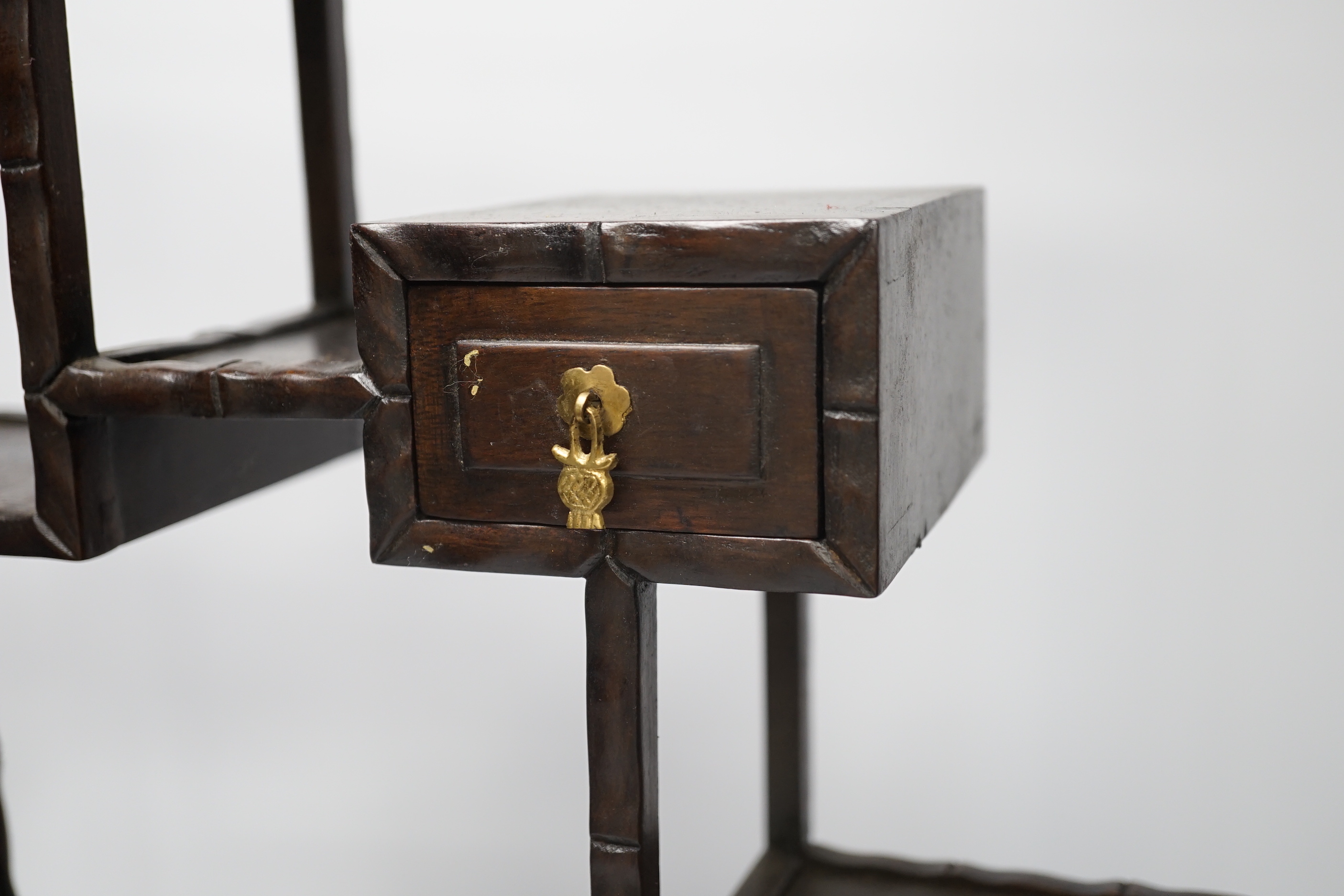 An early 20th century Chinese hongmu display shelf with cupboard and drawer, 46cm high